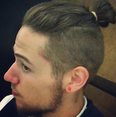 An-image-of-a-young-guy-with-a-man-bun-undercut-hairstyle-and-a-short-boxed-beard