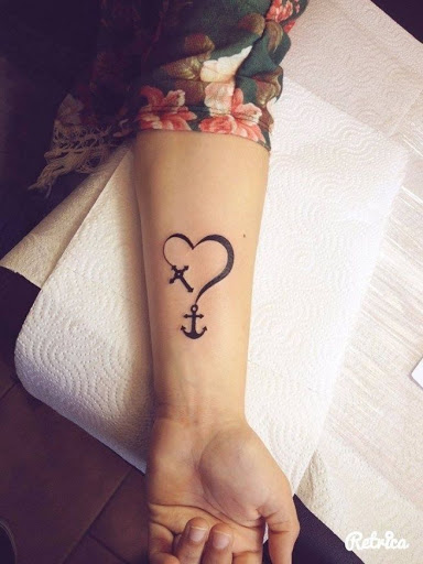 Anchor with cross and heart tattoo on wrist is awesome design