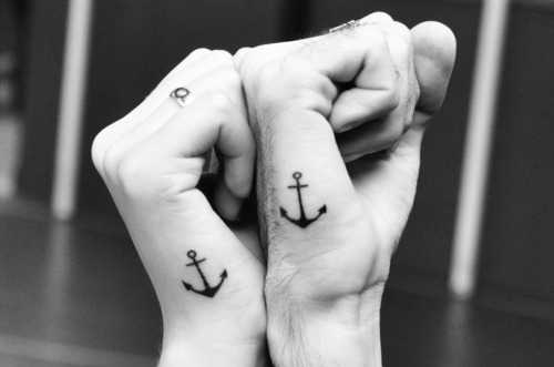 Matching Anchor tattoos on hand for the couples
