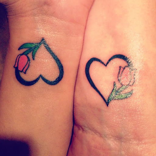 Same heart tattoos designs on wrist and palm, it shows the love for each other