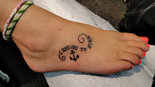 Small Anchor with quote tattoo looking pretty on foot
