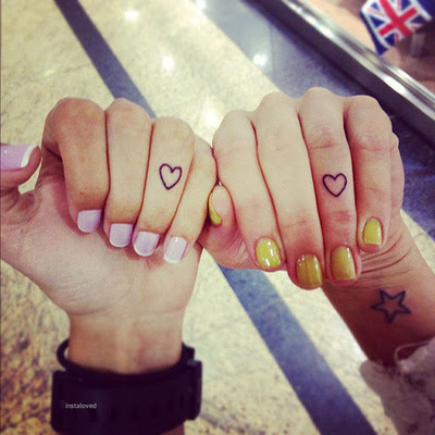Small heart tattooed on ring finger and star on wrist looking awesome
