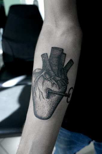 Very famous heart and lock tattoo design on inner forearm