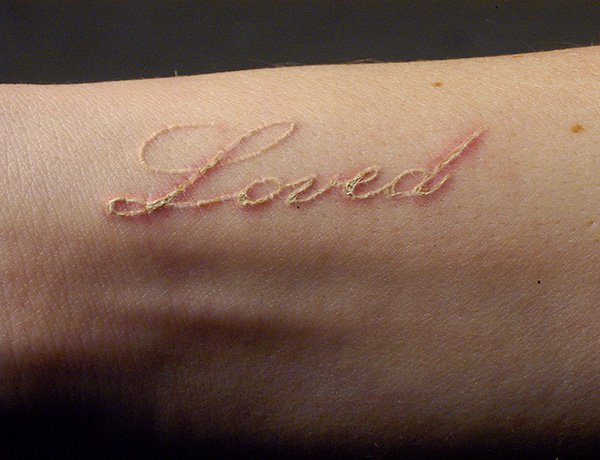 White-ink-loved-tattoo