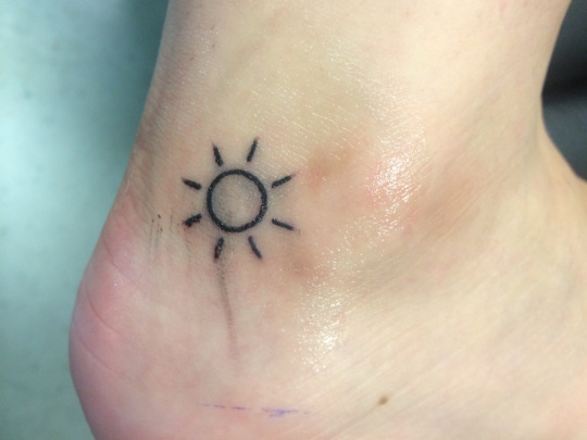 small sun tattoo designs on outer Ankle