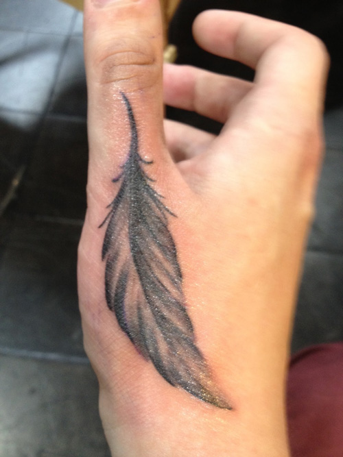 A-feather-hand-tattoo