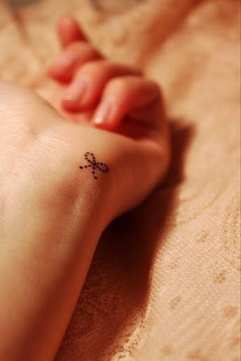 bow small tattoo on wrist
